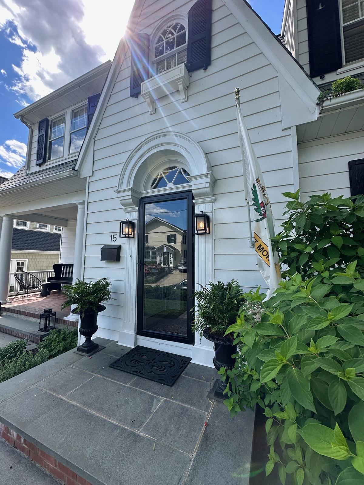 Exterior carriage lantern lights installed at a home front entry
