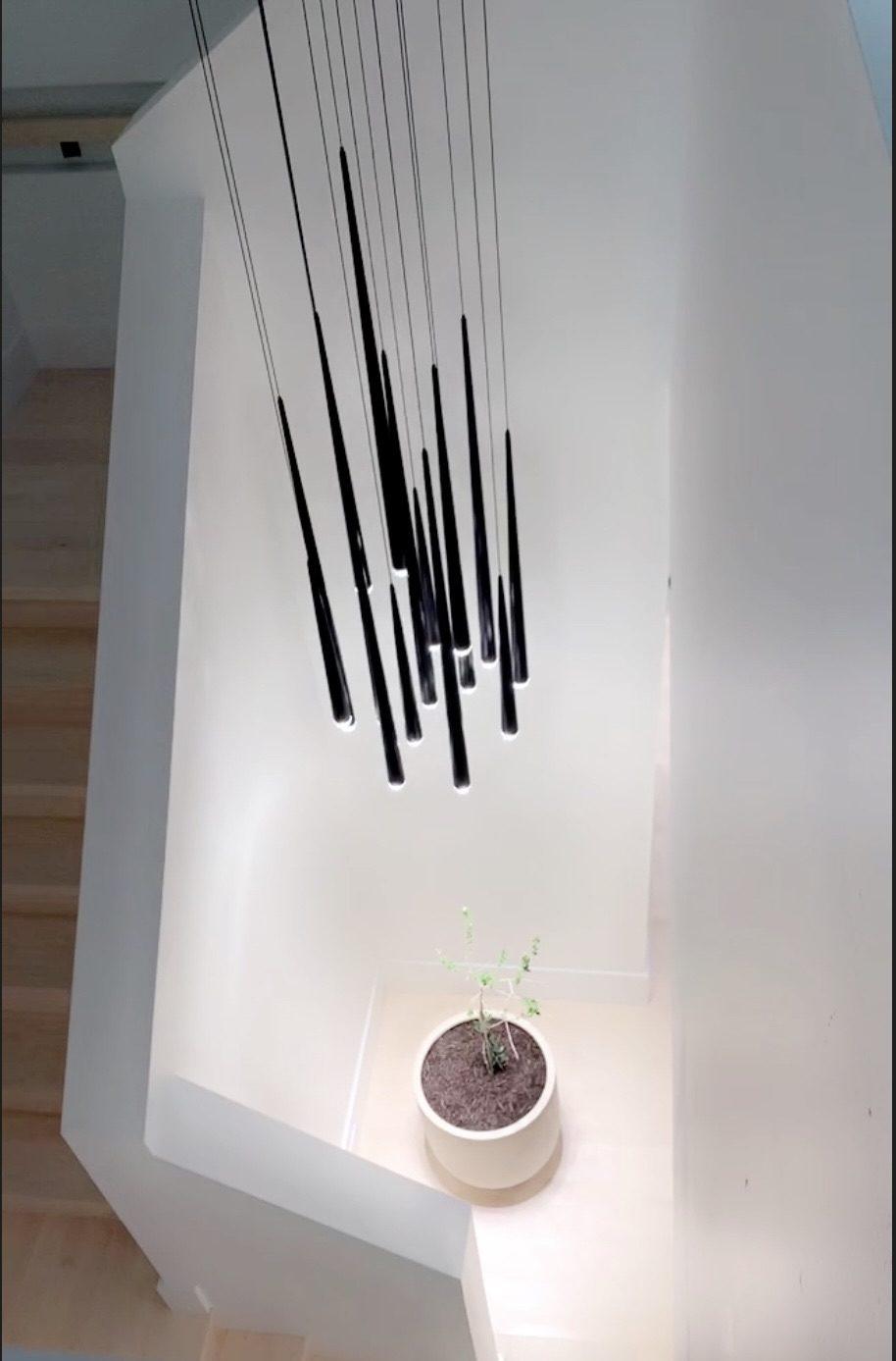 Statement pendant light fixture over stairwell